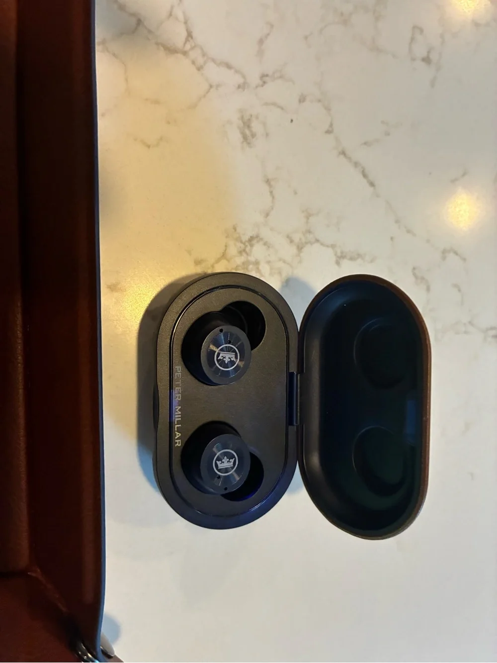 Peter Millar wireless charging catch and wireless headphones
